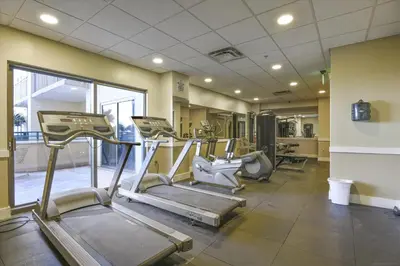 a gym with several tread machines in a room at Origin at Seahaven 403 - Spacious 3 Bedroom withSunset View! Free Fun! condo in Panama City Beach