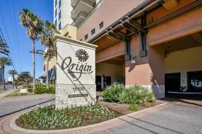 a sign for a hotel in front of a building at Origin at Seahaven 403 - Spacious 3 Bedroom withSunset View! Free Fun! condo in Panama City Beach