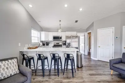 a kitchen with a island with bar stools in it at Private Pool and Hot Tub at Panama City Home! in Panama City Beach