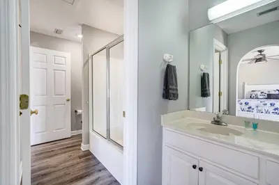 a bathroom with a sink and a mirror at Private Pool and Hot Tub at Panama City Home! in Panama City Beach