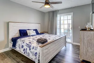 a bedroom with a bed and a ceiling fan at Private Pool and Hot Tub at Panama City Home! in Panama City Beach