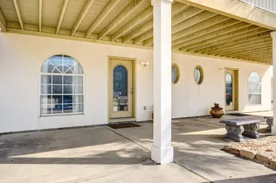 a porch of a house with a pillar and a bench at Private Pool and Hot Tub at Panama City Home! in Panama City Beach