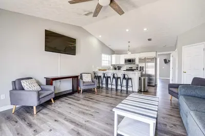 a living room with a couch and a table at Private Pool and Hot Tub at Panama City Home! in Panama City Beach