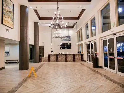 a large lobby with a wooden floor and a chandelier at Spring Break Friendly Ages 21–25+ OK in Panama City Beach