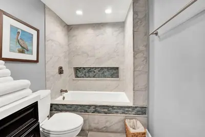 a bathroom with a tub and a toilet and a sink at Spring Break Friendly Ages 21–25+ OK in Panama City Beach