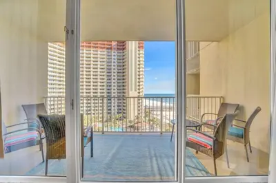 a view of a balcony with chairs and a table at Spring Break Friendly Ages 21–25+ OK in Panama City Beach