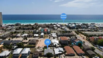 an aerial view of a city with a beach access sign at Blue Neptune at 5313 Sunset Avenue by Nautical Properties Vacation Rentals in Panama City Beach