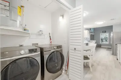 a laundry room with a washer and dryer at Blue Neptune at 5313 Sunset Avenue by Nautical Properties Vacation Rentals in Panama City Beach