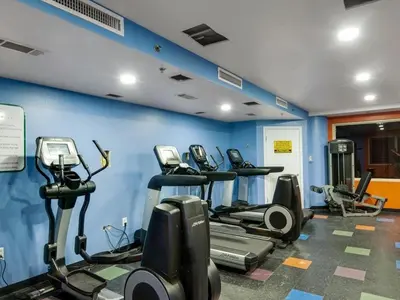 a gym with a bunch of tread machines in a room at Shores of Panama 1206 - Amazing Studio, Free Fun! Sleeps 3, Romantic condo in Panama City Beach