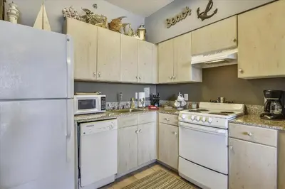a kitchen with white appliances and a white refrigerator at Shores of Panama 1206 - Amazing Studio, Free Fun! Sleeps 3, Romantic condo in Panama City Beach