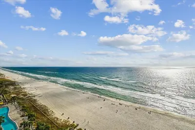 an aerial view of a beach with people on it at Calypso 1205 - Amazing Condo! Free Fun! Sleeps 4, Free Beach Chairs condo in Panama City Beach