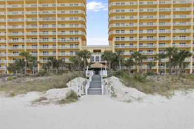a hotel on the beach with stairs leading to the beach at Calypso 1205 - Amazing Condo! Free Fun! Sleeps 4, Free Beach Chairs condo in Panama City Beach