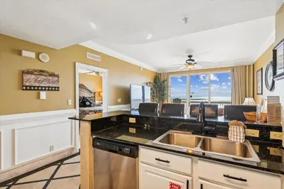 a kitchen with a sink and a counter top at Calypso 1205 - Amazing Condo! Free Fun! Sleeps 4, Free Beach Chairs condo in Panama City Beach