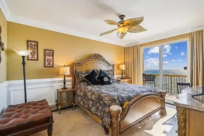a bedroom with a bed and a ceiling fan at Calypso 1205 - Amazing Condo! Free Fun! Sleeps 4, Free Beach Chairs condo in Panama City Beach