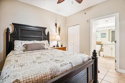 a bedroom with a large bed and a bathroom at Shores of Panama 401 - 4th Floor 3 Bedroom 3 Bath Sleeps 8, Same Floor Resv, Parking! Updated! condo in Panama City Beach