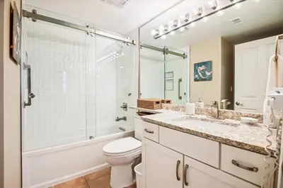 a bathroom with a toilet and a shower and a sink at Shores of Panama 401 - 4th Floor 3 Bedroom 3 Bath Sleeps 8, Same Floor Resv, Parking! Updated! condo in Panama City Beach