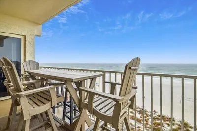 a table and chairs on a balcony with the beach at Shores of Panama 401 - 4th Floor 3 Bedroom 3 Bath Sleeps 8, Same Floor Resv, Parking! Updated! condo in Panama City Beach