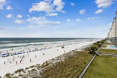 a view of a beach with people on it at Shores of Panama 401 - 4th Floor 3 Bedroom 3 Bath Sleeps 8, Same Floor Resv, Parking! Updated! condo in Panama City Beach