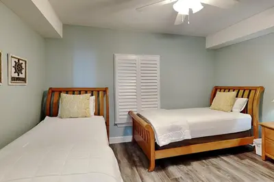 a bedroom with two beds and a window at Emerald Isle Panama City Beach #2208 in Panama City Beach
