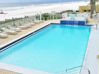 a large blue swimming pool next to a beach at Emerald Isle Panama City Beach #2208 in Panama City Beach