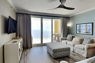 a living room with a couch and a ceiling fan at Emerald Isle Panama City Beach #2208 in Panama City Beach