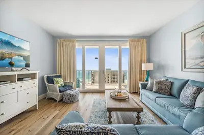 a living room with a couch and a table at Spacious Beach Condo with Gulf Views! Sleeps 8! by Dolce Vita Getaways PCB in Panama City Beach