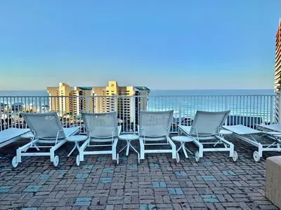 a group of chairs sitting on top of a roof at Spacious Beach Condo with Gulf Views! Sleeps 8! by Dolce Vita Getaways PCB in Panama City Beach