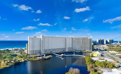 a view of a hotel with the ocean in the background at Spacious Beach Condo with Gulf Views! Sleeps 8! by Dolce Vita Getaways PCB in Panama City Beach