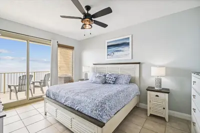 a bedroom with a bed with a ceiling fan and a balcony at Gulf Crest 2005 - 2 Bedroom 2Bathroom withFantastic View! Family Friendly! Sleeps 8 condo in Panama City Beach