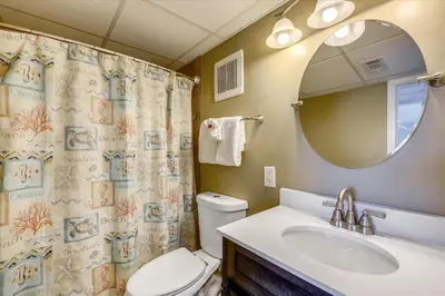 a bathroom with a toilet and a sink and a mirror at Sugar Beach A6-Lovely 4 bedroom 3 bath Condo, Sleeps 11, Free Beach Chairs 2021! condo in Panama City Beach