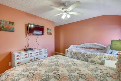 a bedroom with two beds and a ceiling fan at Sugar Beach A6-Lovely 4 bedroom 3 bath Condo, Sleeps 11, Free Beach Chairs 2021! condo in Panama City Beach