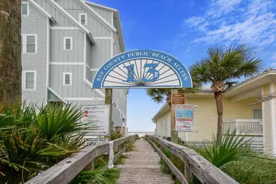a sign for a vacation rental unit with a house at Cozy Holiday Hideaway, Sleeps 4! Steps to the Beach! Renovated 2021 condo in Panama City Beach