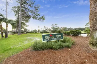 a sign for astand firm in a park at Cozy Holiday Hideaway, Sleeps 4! Steps to the Beach! Renovated 2021 condo in Panama City Beach
