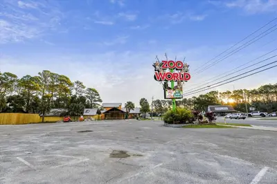 a sign for a word motel in a parking lot at Cozy Holiday Hideaway, Sleeps 4! Steps to the Beach! Renovated 2021 condo in Panama City Beach