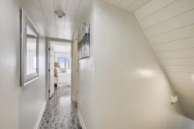 a hallway leading to a bedroom with a white wall at Pinnacle Port A502 - Updated 3 Bedroom 3 Bathroom Sleeps 8, Free Fun! Boat Ramp Access! condo in Panama City Beach