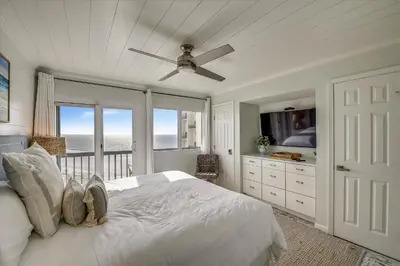 a bedroom with a bed and a balcony with the ocean at Pinnacle Port A502 - Updated 3 Bedroom 3 Bathroom Sleeps 8, Free Fun! Boat Ramp Access! condo in Panama City Beach