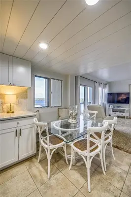 a kitchen and dining room with a glass table and chairs at Pinnacle Port A502 - Updated 3 Bedroom 3 Bathroom Sleeps 8, Free Fun! Boat Ramp Access! condo in Panama City Beach