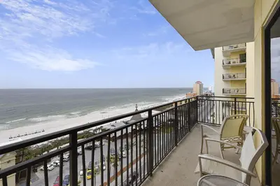 a balcony with chairs and a view of the beach at Origin 1036, Perfect for 4! Beautiful sunset and Gulf of Mexico view! Free Activities! condo in Panama City Beach