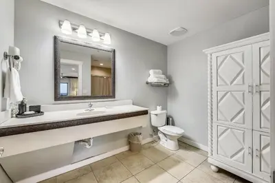 a bathroom with a sink and a toilet and a mirror at Origin 1036, Perfect for 4! Beautiful sunset and Gulf of Mexico view! Free Activities! condo in Panama City Beach