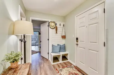 a hallway with a white door and a lamp at Edgewater Villas #2108 - 2 Bedroom 2Bath Sleeps 8, Free Gas Card & Free Fun! condo in Panama City Beach