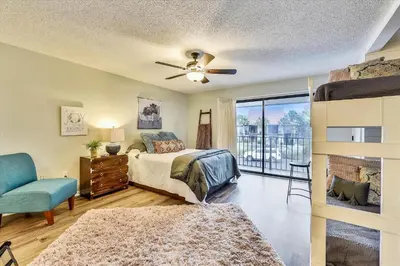 a bedroom with a bed and a ceiling fan at Edgewater Villas #2108 - 2 Bedroom 2Bath Sleeps 8, Free Gas Card & Free Fun! condo in Panama City Beach