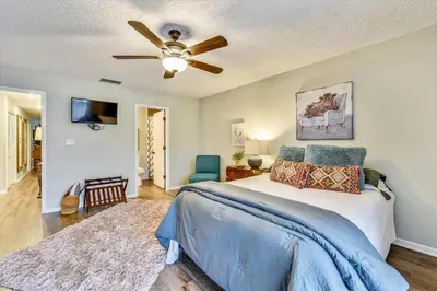 a bedroom with a bed and a ceiling fan at Edgewater Villas #2108 - 2 Bedroom 2Bath Sleeps 8, Free Gas Card & Free Fun! condo in Panama City Beach