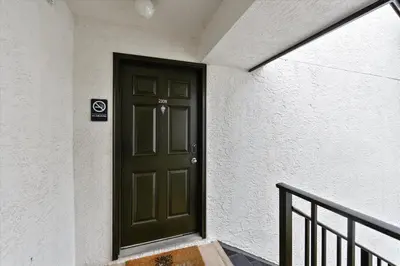 a green door on the side of a building at Edgewater Villas #2108 - 2 Bedroom 2Bath Sleeps 8, Free Gas Card & Free Fun! condo in Panama City Beach