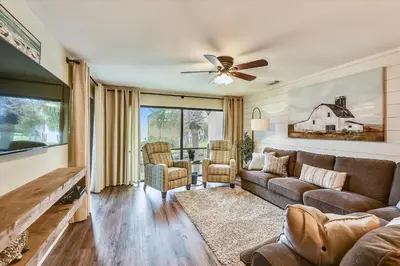 a living room with a couch and a ceiling fan at Edgewater Villas #2108 - 2 Bedroom 2Bath Sleeps 8, Free Gas Card & Free Fun! condo in Panama City Beach
