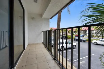 a balcony with a view of a parking lot at Edgewater Villas #2108 - 2 Bedroom 2Bath Sleeps 8, Free Gas Card & Free Fun! condo in Panama City Beach