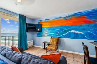 a living room with a painting on the wall at Shores of Panama 1506, Perfect for a Great Couples Getaway! Free Fun! Reserved Parking condo in Panama City Beach