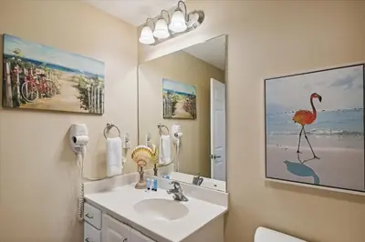 a bathroom with a sink and a large mirror at Sterling Reef 202 - 2nd Floor withUninterrupted Gulf View! Free Fun! Free Gas Card! condo in Panama City Beach