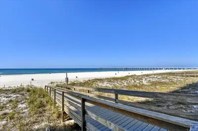 a wooden boardwalk leading to the beach with a pier at Sterling Reef 202 - 2nd Floor withUninterrupted Gulf View! Free Fun! Free Gas Card! condo in Panama City Beach