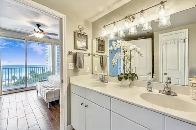 a bathroom with two sinks and a large mirror at Shores of Panama 620-Sleeps 8, Free Fun! Reserved Parking Space! Updated! condo in Panama City Beach