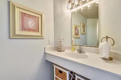 a bathroom with a sink and a mirror at Shores of Panama 620-Sleeps 8, Free Fun! Reserved Parking Space! Updated! condo in Panama City Beach